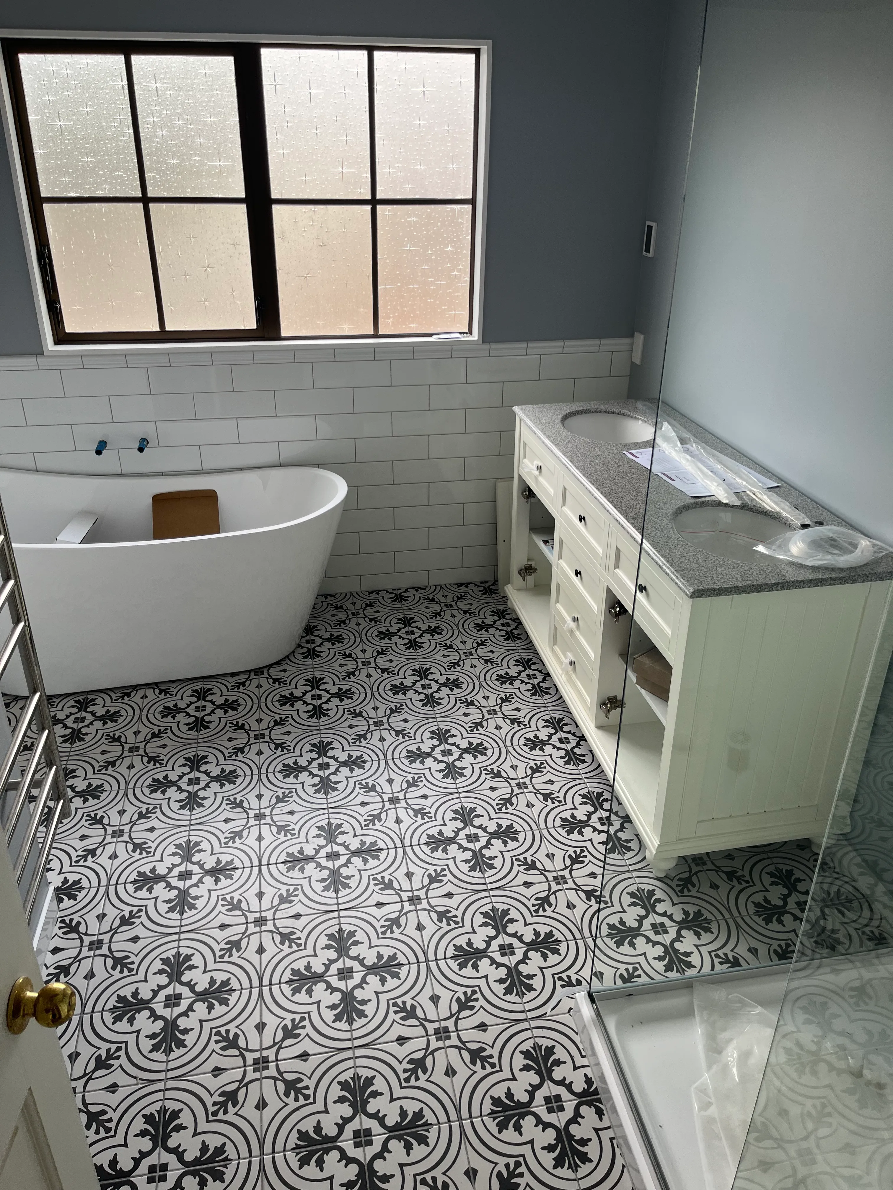 Bathroom renovation featuring patterned wall tiles and modern fixtures